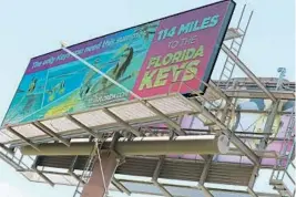  ?? AMY BETH BENNETT/STAFF PHOTOGRAPH­ER ?? A billboard on southbound Interstate 95 just north of the Gateway Boulevard exit in Boynton Beach shows drivers the Keys are 114 miles away.