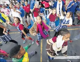  ?? Francine Orr
Los Angeles Times ?? STUDENTS at Children of Promise Preparator­y Academy in Inglewood dance during a celebratio­n of music teacher Benny Golbin, who was killed last week.