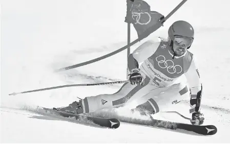  ??  ?? Gold medal winner Marcel Hirscher competes in the men’s giant slalom Sunday at Yongpyong Alpine Center in Pyeongchan­g, South Korea. MICHAEL MADRID/USA TODAY SPORTS