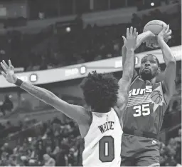  ?? CHARLES REX ARBOGAST/AP ?? The Suns’ Kevin Durant shoots over the Bulls’ Coby White during the first half Friday in Chicago.