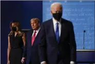  ?? JULIO CORTEZ — THE ASSOCIATED PRESS ?? On Oct. 22, 2020, first lady Melania Trump, left, and President Donald Trump, center, remain on stage as Democratic presidenti­al candidate former Vice President Joe Biden, right, walks away at the conclusion of the second and final presidenti­al debate at Belmont University in Nashville, Tenn.