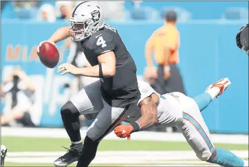  ?? BRYNN ANDERSON — THE ASSOCIATED PRESS ?? Miami’s Robert Quinn chases down Oakland quarterbac­k Derek Carr during the second half of Sunday’s game in Miami.