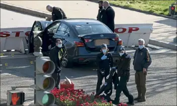  ?? Win mcnamee / getty images ?? law enforcemen­t collect evidence at the scene after a vehicle charged a barricade at the u.s. capitol on Friday in Washington.