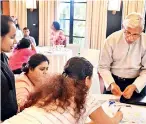  ??  ?? Former Digital Infrastruc­ture Ministry Secretary Wasantha Deshapriya actively participat­es in a session with one of the teams