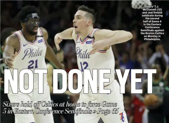  ?? THE ASSOCIATED PRESS ?? 76ers’ T.J. McConnell (12) and Joel Embiid celebrate during the second half of Game 4 in the Eastern Conference Semifinals against the Boston Celtics on Monday in Philadelph­ia.