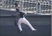  ?? JAE C. HONG — THE ASSOCIATED PRESS ?? Tampa Bay Rays right fielder Manuel Margot reaches over the wall after catching a foul ball by the Houston Astros’ George Springer during the second inning in Game 2of the AL Championsh­ip Series on Monday in San Diego.