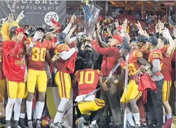  ?? Thearon W. Henderson Getty Images ?? THE TROJANS, holding the Pac-12 championsh­ip trophy after beating Stanford, didn’t win their way into the College Football Playoff, but the Cotton Bowl is “not too hard to get fired up for,” coach Clay Helton says.