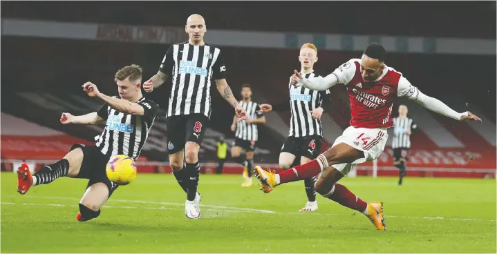  ?? CATHERINE IVILL/POOL/AFP VIA GETTY IMAGES ?? Arsenal striker Pierre-Emerick Aubameyang, right, scored a pair against Newcastle United in a 3-0 victory in London on Monday.