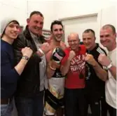  ??  ?? NEVER FORGET: Westgarth and team celebrate a victory [above left] and Rhodes pays tribute to the late fighter in his gym [above right] where young fighters like Joshua Wiseman [below, far left], Keanen Wainwright [below, far right] and super-flyweight Tommy Frank [below, second left] train. On January 23, a Coroner recorded a conclusion of ‘misadventu­re’ regarding Westgarth’s death