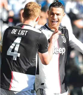  ??  ?? Juventus’ Matthijs de Ligt, left, celebrates with his teammate Cristiano Ronaldo after scoring his side’s third goal against Fiorentina. Photo: AP