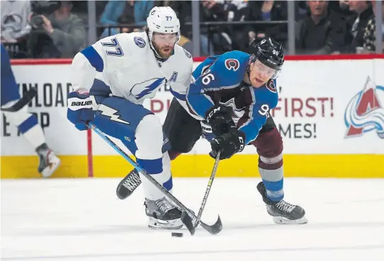  ?? David Zalubowski, The Associated Press ?? Tampa Bay Lightning defenseman Victor Hedman, left, fights for control of the puck with Avalanche right wing Mikko Rantanen during the first period Monday night at the Pepsi Center.