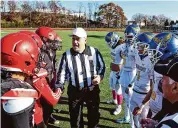  ?? Ned Gerard/Hearst Connecticu­t Media ?? CIAC referee Tom Sportina meets with the members of the Central and Harding teams prior to kickoff of their annual Thanksgivi­ng Day game at Kennedy Stadium in Bridgeport on Nov. 24, 2022.