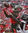  ?? AP Photo/Jason Behnken, File ?? ■ In this Dec. 29, 2019, file photo, Tampa Bay Buccaneers wide receiver Breshad Perriman (19) pulls in a 24-yard touchdown reception in front of Atlanta Falcons outside linebacker De'Vondre Campbell (59) during the first half of an NFL football game in Tampa, Fla.