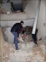  ?? DHA VIA AP ?? Two men check inside a badly damaged building after a 6.8 earthquake struck Elazig city centre in the eastern Turkey, Friday.