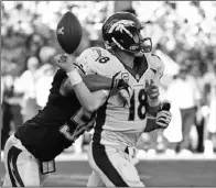  ?? DENIS POROY / ASSOCIATED PRESS ?? Peyton Manning fumbles as he is hit by San Diego Chargers outside linebacker Tourek Williams during the third quarter of their NFL game on Sunday in San Diego. The Chargers recovered the fumble and scored a touchdown a few plays later.