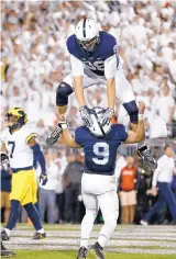  ?? CHRIS KNIGHT/ASSOCIATED PRESS ?? Penn State’s Mike Gesicki (88) celebrates by jumping over QB Trace McSorley after McSorley’s first-half touchdown against Michigan.