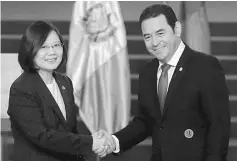  ??  ?? Tsai and her Guatemalan counterpar­t Jimmy Morales shake hands during a joint news conference at the Presidenti­al Palace in Guatemala City, Guatemala. — Reuters photo