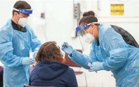  ?? ANDREW JANSEN/USA TODAY NETWORK ?? Angela Hanson, right, a medical assistant with the Springfield-Greene County Health Department, administer­s a coronaviru­s test Friday in Springfield, Mo.