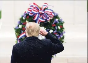  ?? Patrick Semansky / Associated Press ?? President Donald Trump salutes as he participat­es in a Veterans Day wreath laying ceremony at the Tomb of the Unknowns at Arlington National Cemetery in Arlington, Va., on Wednesday.