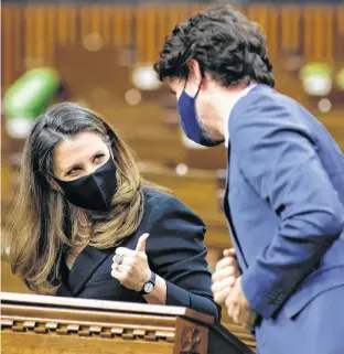  ?? BLAIR GABLE REUTERS ?? Canada’s Finance Minister Chrystia Freeland gives a thumbs up to Prime Minister Justin Trudeau during the delivery of the federal budget in the House of Commons on Parliament Hill in Ottawa on Monday. •