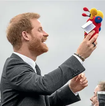  ??  ?? Prince Harry with his new crocheted buzzy bee. It’s got wheels of wool, Harry! How are you even going to pull it?
