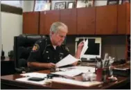  ?? THE ASSOCIATED PRESS ?? Lucas County Sheriff John Tharp looks through papers in his office in Toledo, Ohio. Police and rescue crews say drivers overdosing on heroin and other drugs are driving up the number of car crashes. Tharp says drivers in his county overdose on opioids...