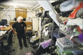  ?? Marcio Jose Sanchez / Associated Press ?? Terry Schoop, community services department manager for Burning Man festival, looks through lost and found items at the organizati­on’s San Francisco headquarte­rs.