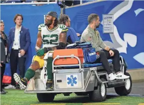  ?? PAUL SANCYA/AP ?? Packers linebacker Rashan Gary is carted off the field during the second half of a game against the Lions at Ford Field. Gary tore his ACL.