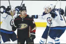  ?? Associated Press ?? Winnipeg Jets center Paul Stastny (left) celebrates scoring a goal with left wing Nikolaj Ehlers (second from right) and defenseman Brenden Dillon (right) behind Anaheim Ducks defenseman Hampus Lindholm (second from left) during the third period in Anaheim on Tuesday. The Jets won the game 4-3.