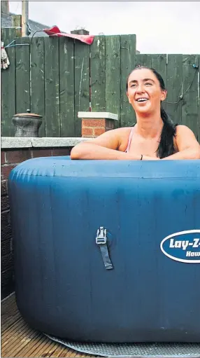  ??  ?? Jacqueline Flanagan, right, is joined by daughter Kathleen in the hot tub at home in Bellshill, Lanarkshir­e