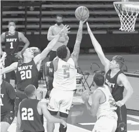  ?? KARL MERTON FERRON/THE BALTIMORE SUN ?? Navy guard Greg Summers (20) and forward Daniel Deaver fail to stop Maryland guard Eric Ayala from scoring in the paint during the first half Friday in College Park.