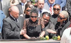  ?? KEITH SRAKOCIC/AP ?? Friends and family members console Kalabrya Haskins, the widow of Dwayne Haskins, after a memorial service Friday in Pittsburgh.