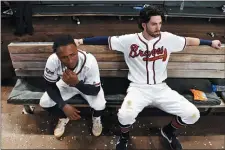  ?? JOHN AMIS — THE ASSOCIATED PRESS ?? Atlanta’s Dansby Swanson, right, and Ozzie Albies sit in the dugout after the Braves lost 13-1to the St. Louis Cardinals in Game 5of their National League Division Series.