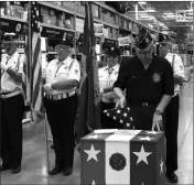  ?? Buy these photos at YumaSun.com PHOTOS BY BLAKE HERZOG/YUMA SUN ?? CONNIE TYREE, PAST COMMANDER of American Legion Post 19, deposits a worn-out flag into a box built for that purpose at the Lowe’s store in Yuma, backed by the legion’s color guard, on Friday. The box will be placed next to the entrance door.