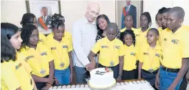  ?? RUDOLPH BROWN/PHOTOGRAPH­ER ?? Lady Allen watches as her husband Sir Patrick, governor general of Jamaica, is assisted by The Gleaner’s Children’s Own Spelling Bee Champion, Darian Douglas in cutting his birthday cake during a courtesy call by the 14 finalists at King’s House Sir Patrick celebrated his 68th birthday.