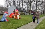  ?? JORDANA JOY — THE MORNING JOURNAL ?? Lacey, 4, left, and Kara Blackburn, 36, of Avon Lake strolled around the Landings neighborho­od as a part of a “zoofari” neighborho­od walk March 27.