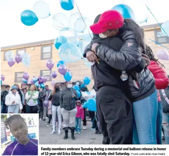  ?? TYLER LARIVIERE/SUN-TIMES ?? Family members embrace Tuesday during a memorial and balloon release in honor of 12-year-old Erica Gibson, who was fatally shot Saturday.