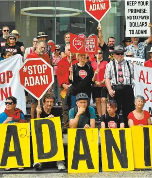  ??  ?? Protesters against the Adani coalmine rally outside the company’s Brisbane headquarte­rs in October.