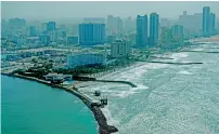  ??  ?? Ajman coastline in contrast to its sprawling urban developmen­t. The seaplane is the latest new attraction from the emirate.