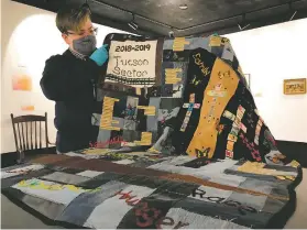  ?? HENRY BREAN/ASSOCIATED PRESS ?? Trish Norman, state museum collection­s manager for the Arizona Historical Society, unfolds a quilt from the Migrant Quilt Project at the state museum in Tucson last week.