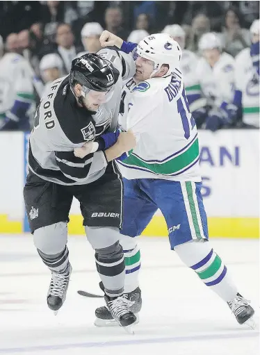  ?? — THE ASSOCIATED PRESS ?? Kyle Clifford of the Kings trades punches Vancouver’s Derek Dorsett during the first period of Saturday night’s game in Los Angeles.