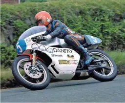  ??  ?? LEFT: 1976, and Chas heads to victory in the Junior TT on his Yamaha