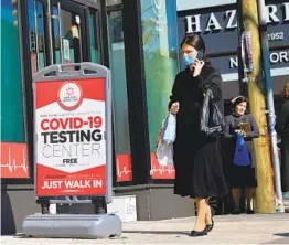  ?? ANGELA WEISS AFP VIA GETTY IMAGES ?? A person walks past a COVID-19 testing center in Brooklyn on Friday. N.Y. Gov. Andrew Cuomo has tightened restrictio­ns in parts of Brooklyn and elsewhere.