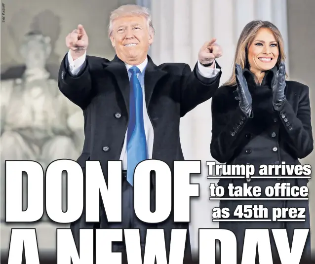  ??  ?? In the shadow of Abraham Lincoln, Donald Trump and wife Melania celebrate yesterday as he prepared to take the oath of office as president today.