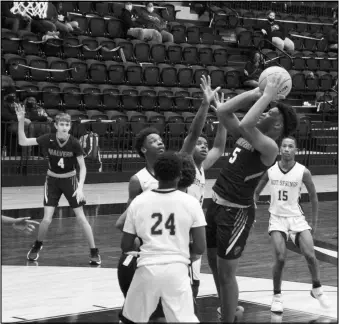  ?? Photo by Alexis Meeks ?? Malvern’s Kealen Juniel shoots the ball over three defenders during a recent game. Juniel led the 9th grade Cubs in scoring against the Fountain Lake Jr. Cobras with 10 points.