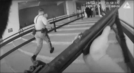  ?? METRO POLICE DEPARTMENT VIA AP ?? In this image made from body camera footage provided by Metro Police, officers run into a building Dec. 6 on the UNLV campus in response to reports of a shooting. Police body camera footage from the shooting, which left three people dead and one wounded, was released Dec. 20. Another batch of video released Tuesday offers the first audio of the shootout that ended the gunman’s life.