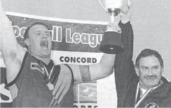  ??  ?? Captain coach Ash Green holds the premiershi­p cup aloft alongside president Bob Baldry, when Warragul broke a 19 year flag hoodoo in 2003. (file photos)