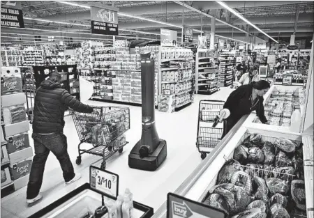  ?? MATT ROURKE/AP ?? The accelerati­on of AI will disrupt a chunk of U.S. jobs in the future, a think tank says. Above, a robot cleans floors at a grocery store in Harrisburg, Pa.