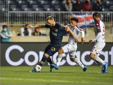  ?? SUBMITTED PHOTO - THE UNION ?? Union forward Kacper Przybylko, left, battles with Deportivo Saprissa’s Jedwin Lester in the first half of their CONCACAF Champions League game Wednesday. Przybylko scored for the second straight game as the Union advanced to the quarterfin­als, 4-0(5-0on aggregate).