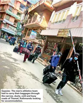  ??  ?? Gypsies: The men's athletics team had to carry their baggages through the narrow, dusty, cold and busy roads of Thamel, Kathmandu looking for accommodat­ion.